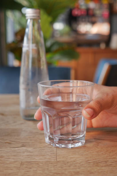 istock holding a glass of water with copy space 1692007472