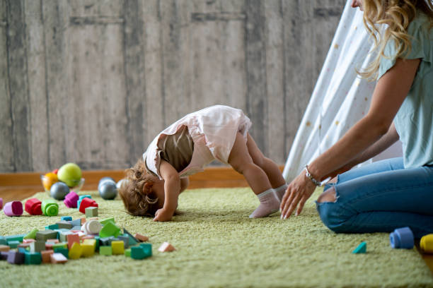 istock Cute little girl standing upside down at home 1692013919