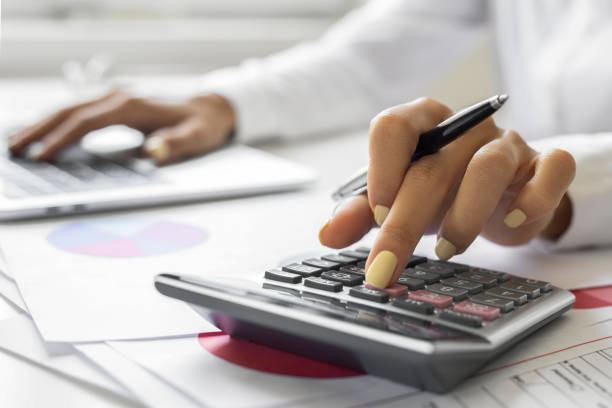 istock Finance, accounting and fintech, a woman on a computer and calculator 1692025884