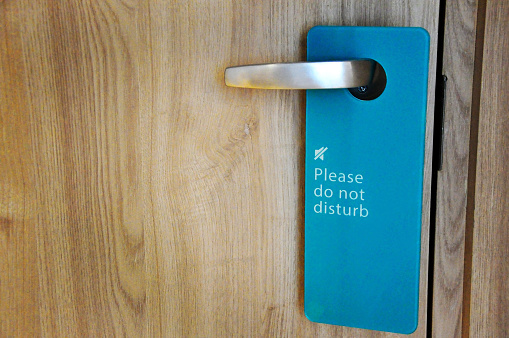 Blue door hanger tag please do not disturb hang on handle of wooden door