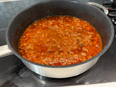 Bolognaise sauce in pan on hob