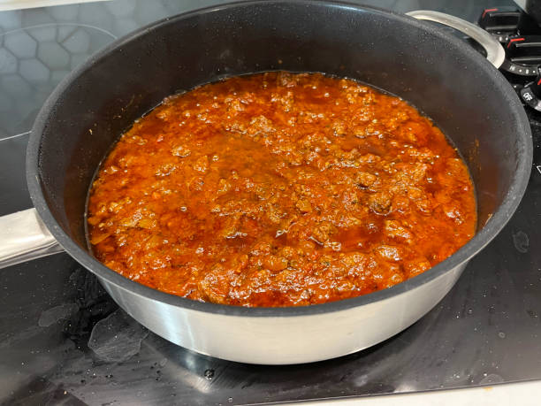 Bolognaise sauce in pan on hob stock photo