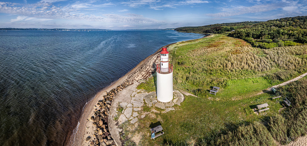 Lighthouse by the Baltic sea, in Estonia, As daylight begins yielding to twiligh, beautiful sunset light, drone photography