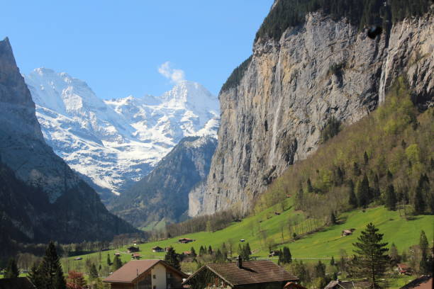 istock Switzerland mountains and waterfall, snow covered mountain, Houses 1692045497