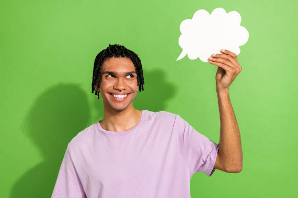 istock Photo of minded creative person beaming smile look arm hold empty space cloud shape bubble card isolated on green color background 1692053057