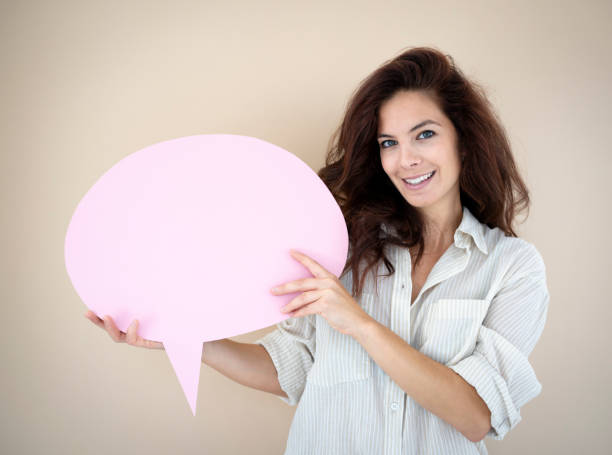 istock beautiful young woman with pink speech bubble 1692055438