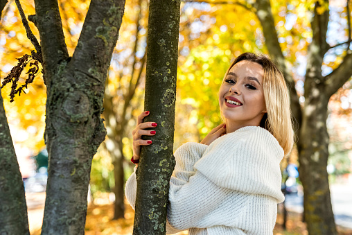 Portrait of beautiful girl in autumn park, spend and enjoy free time at nature. Lifestyle