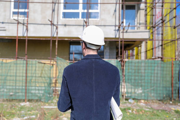istock Back view of the engineer in worker helmet 1692081943