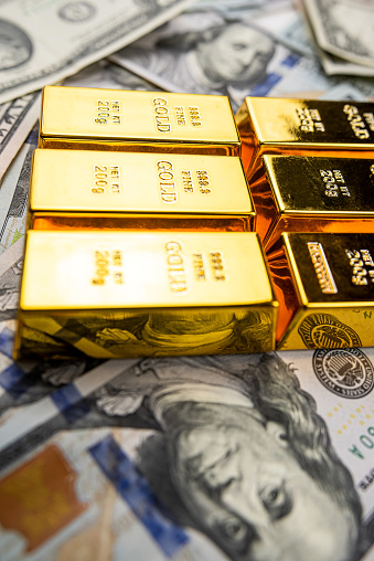gold bars over dollar money bills, investment saving concept. finance and banking