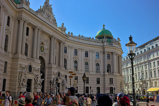 Vienna, Austria - June 29, 2023: Right wing of the Hofburg Imperial Palace in Vienna, Michaelertor. Hofburg palace on St. Michael square (Michaelerplatz). Popular tourist attraction.