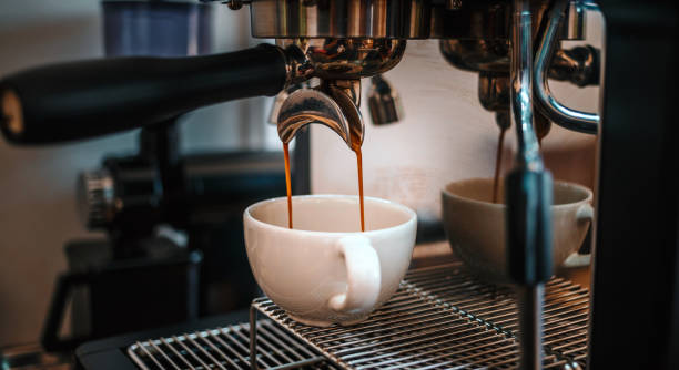 istock Coffee extraction from the coffee machine with a portafilter pouring coffee into a cup,Espresso pouring from the coffee machine at coffee shop 1692110157
