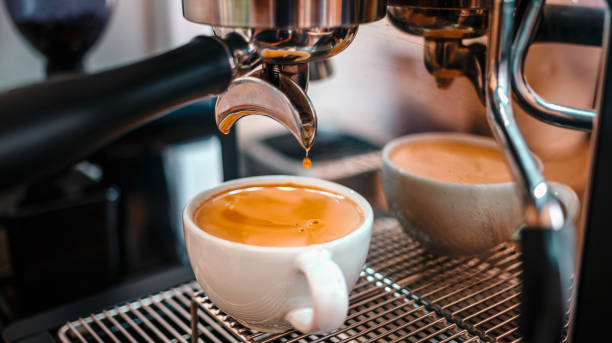 istock Coffee extraction from the coffee machine with a portafilter pouring coffee into a cup,Espresso pouring from the coffee machine at coffee shop 1692110164