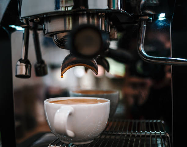 istock Coffee extraction from the coffee machine with a portafilter pouring coffee into a cup,Espresso pouring from the coffee machine at coffee shop 1692110165