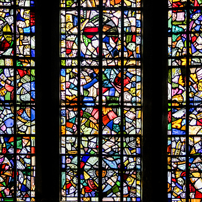 Santiago de Compostela traditional cross, multi colored stained glass window .Santiago church, Boente, camino de Santiago, A Coruña province, Galicia, Spain.