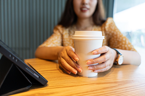 Women holding cup of coffee at cafe