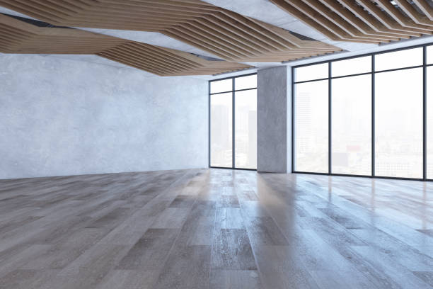 istock Modern empty spacious concrete interior with mock up place on wall, wooden flooring, windows, city view and daylight. 3D Rendering. 1692140625