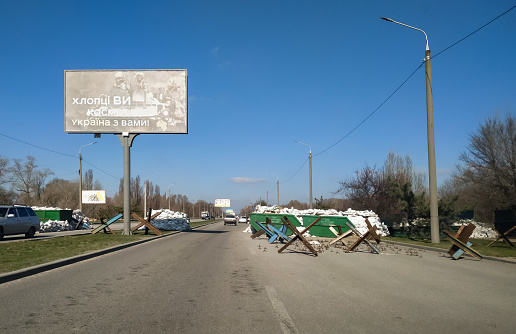 Zaporizhzhia, Ukraine - April 6, 2022: Protective barricades and anti-tank barriers (zech hedgehogs) on the street