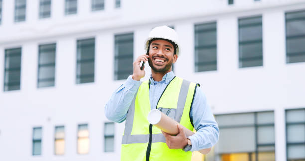 istock Excited, confident and happy architect talking on phone, agreeing to building plan for office development in city. Cheerful, ambitious contractor or surveryor negotiating blueprint deal on technology 1692149917