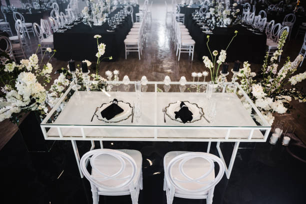 istock Serving, setting newlyweds table. Plate and glass, stack, wineglass, luxury rich decor, black napkin. Wedding set up, dinner table reception. Birthday, event. Restaurant interior. Top view. 1692151080