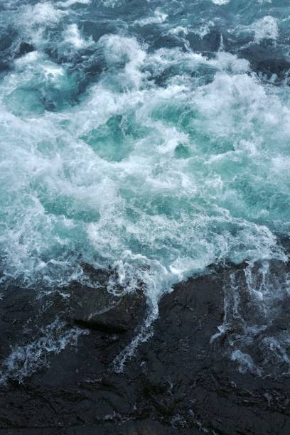 istock Blue, storming, thunderous water beside a dark rock side. Majestic blue,  powerful, elevating atmosphere, Zen. 1692153334