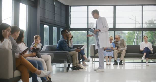istock Diverse people sit on sofas in clinic waiting area 1692153369