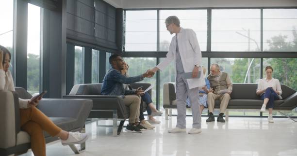 istock Diverse people sit on sofas in clinic waiting area 1692153464