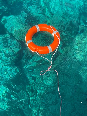 orange lifebuoy in the beautiful middle of the sea, Lampedusa. 19 September 2023