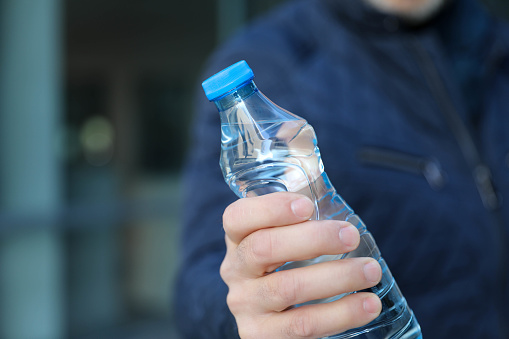 Middle-aged business man with a bottle of water in his hand