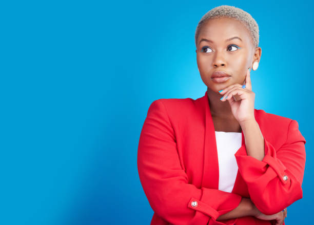 istock Entrepreneur, thinking and black woman with a decision on studio, blue background or mockup with ideas for career. Startup, choice or person with question, doubt or professional mind for business 1692173096
