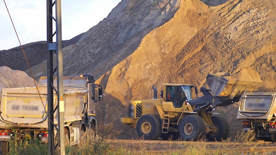 Front Loader Loading Sand On Dumper Trucks On Construction Site Stock ...