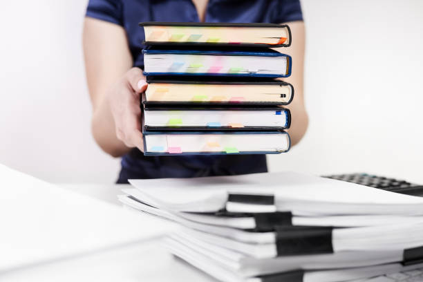 istock An office worker shifts a stack of notebooks with colorful bookmarks 1692181346