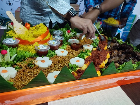 Tumpeng rice dish with side dishes.  Usually served at birthday events