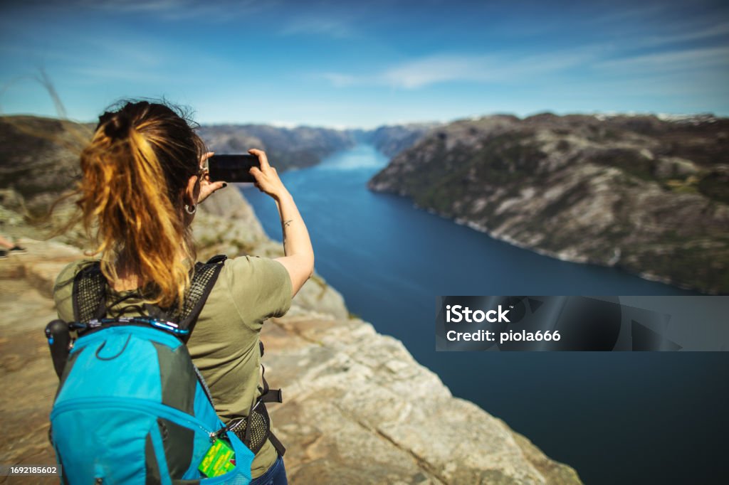 Woman outdoor adventures: hiking in Norway, on the way to Preikestolen cliff 30-34 Years Stock Photo
