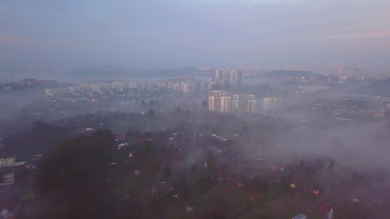 Aerial of Residential Blocks of Flats on Hills Covered in Fog in Misty Morning
