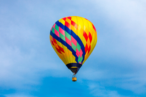 Colorful hot air balloon flying over blue sky