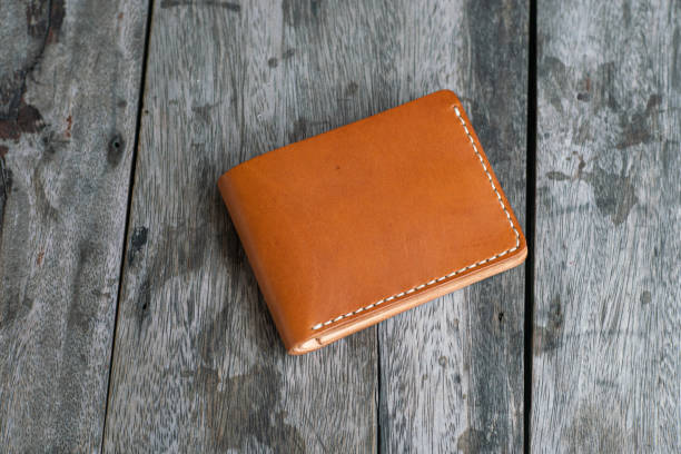 istock Tan brown leather bifold wallet on wood background 1692191237