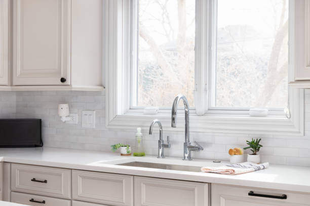istock A kitchen sink detail with tan cabinets and white subway tile backsplash. 1692191297