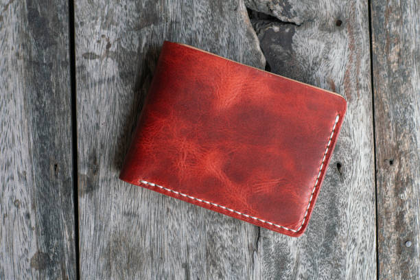 Red genuine cow leather bifold men wallet on wood