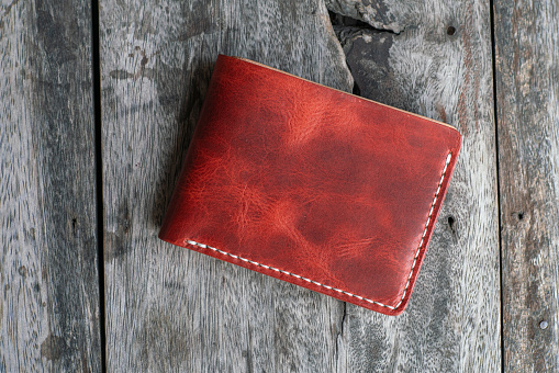 Red genuine cow leather bifold men wallet on wood craftmanship