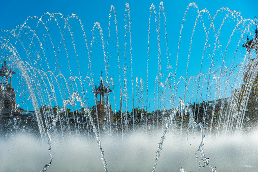 A water fountain runs in a public park.