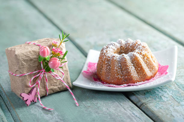 istock Cute little cake on wood with a present 1692196220