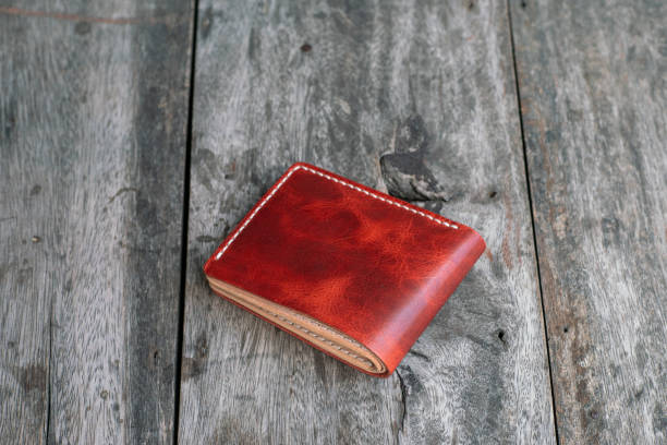 istock Red genuine cow leather bifold men wallet on wood 1692197106