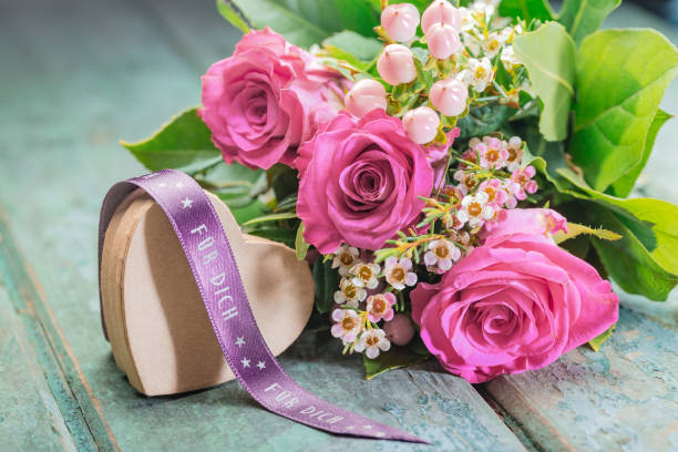 istock Heart-shaped present with a bunch of roses 1692197112