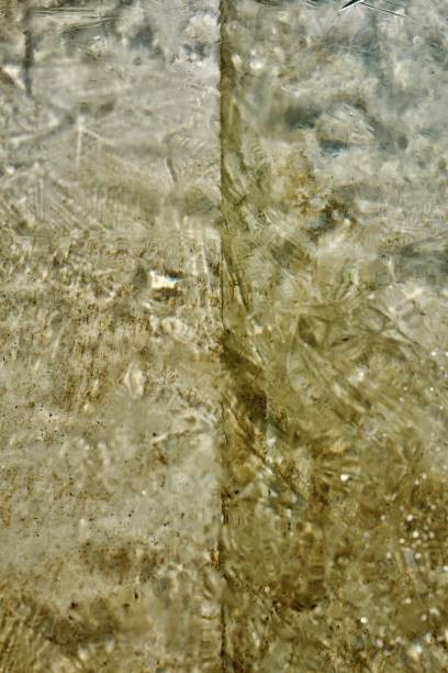 istock Frozen water, gold, silver reflections, pattern, structures visible, textured view of the gray, golden bedrock 1692201338