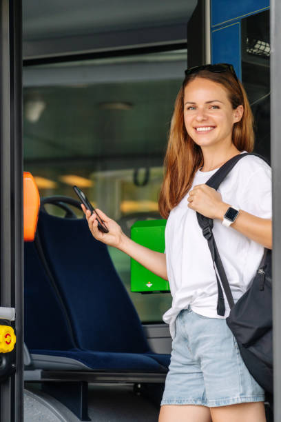 istock Happy young woman using qr code of free pass for shuttle bus in city, looking at camera and smiling. 1692216357