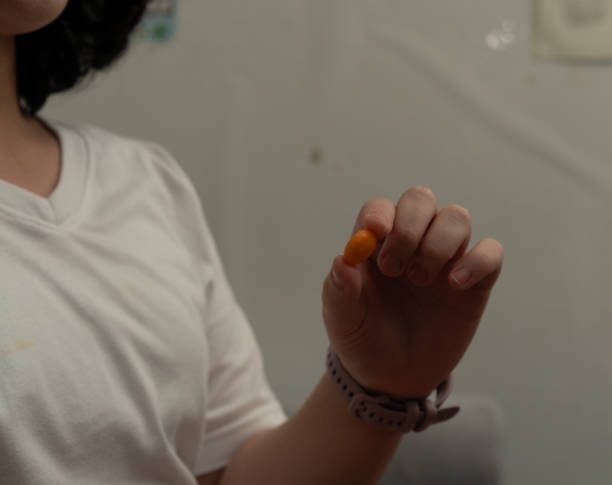 istock Finger hold round candy show to camera 1692217000
