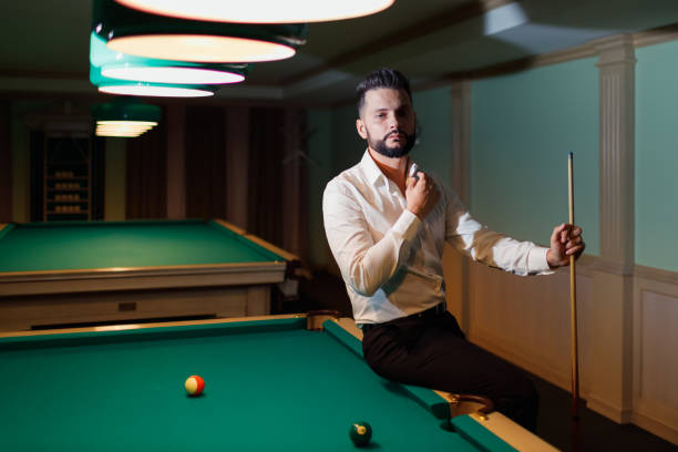 Photo of a young boy playing pool (billiards) processed in an Instagram style.