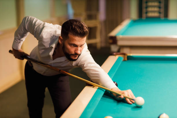 istock Billiard player at billard table or snooker american billiards pool sport game 1692223853