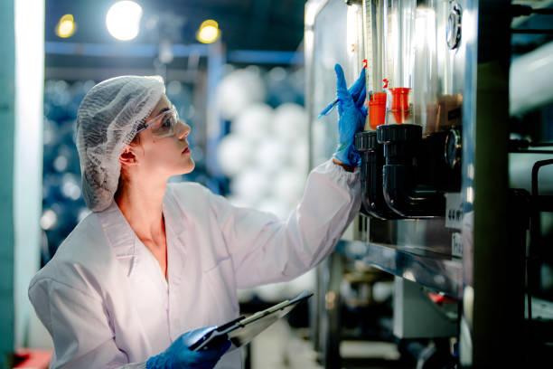 istock scientist worker checking the quality of Reverse osmosis machine system at the industrial factory. Female worker recording data at the control panel with measure pressure for recycle portable plant. 1692232581