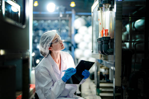 istock scientist worker checking the quality of Reverse osmosis machine system at the industrial factory. Female worker recording data at the control panel with measure pressure for recycle portable plant. 1692234124